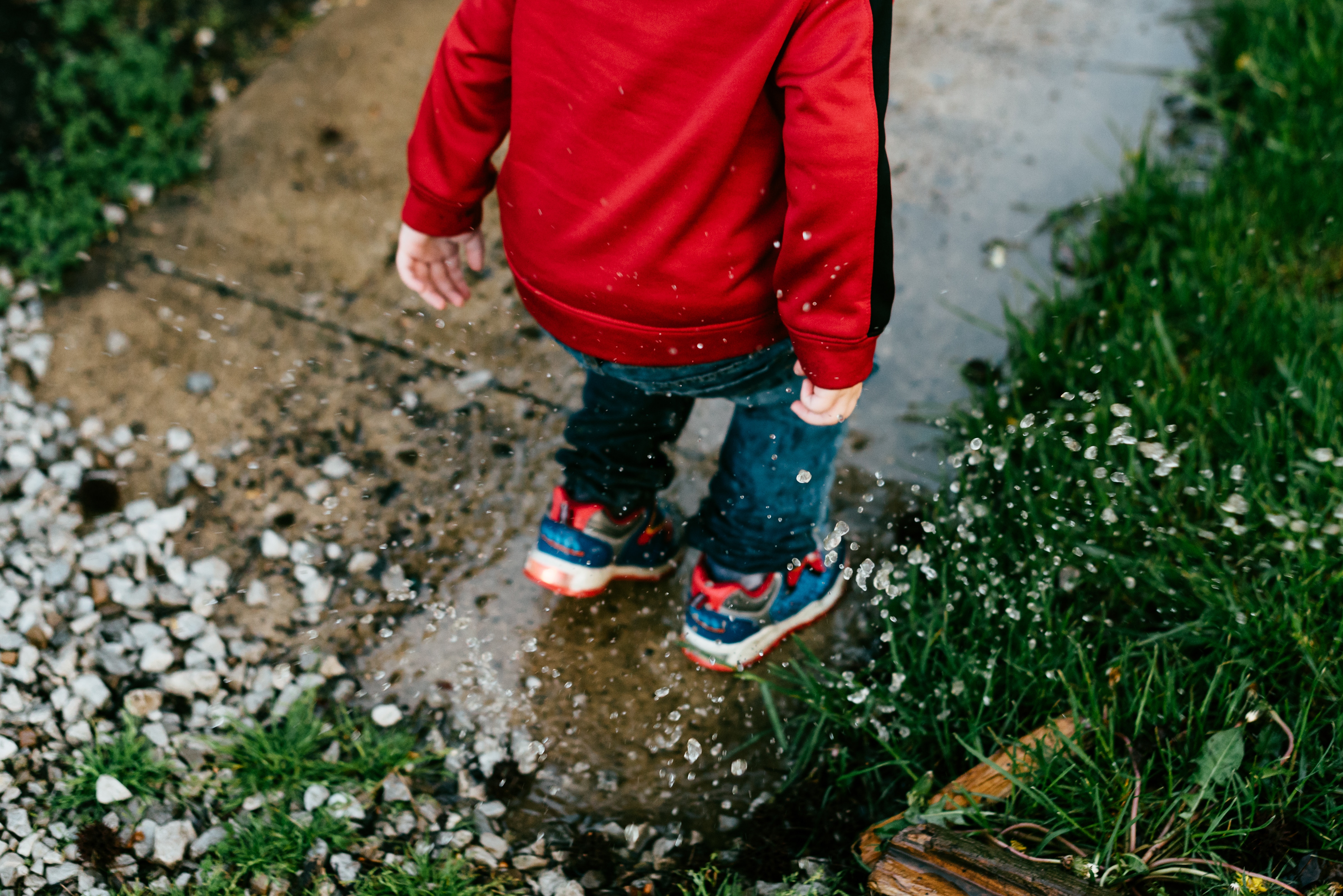 kid splashing in puddles