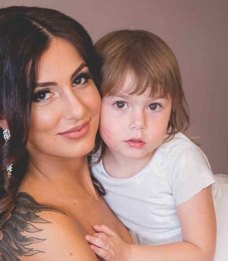 mom holding daughter