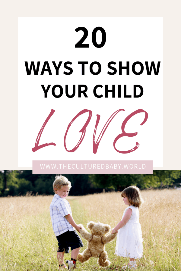 little boy and girl holding a teddy bear in a field 