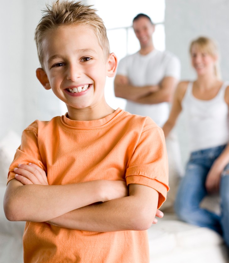 confident child standing in front of parents
